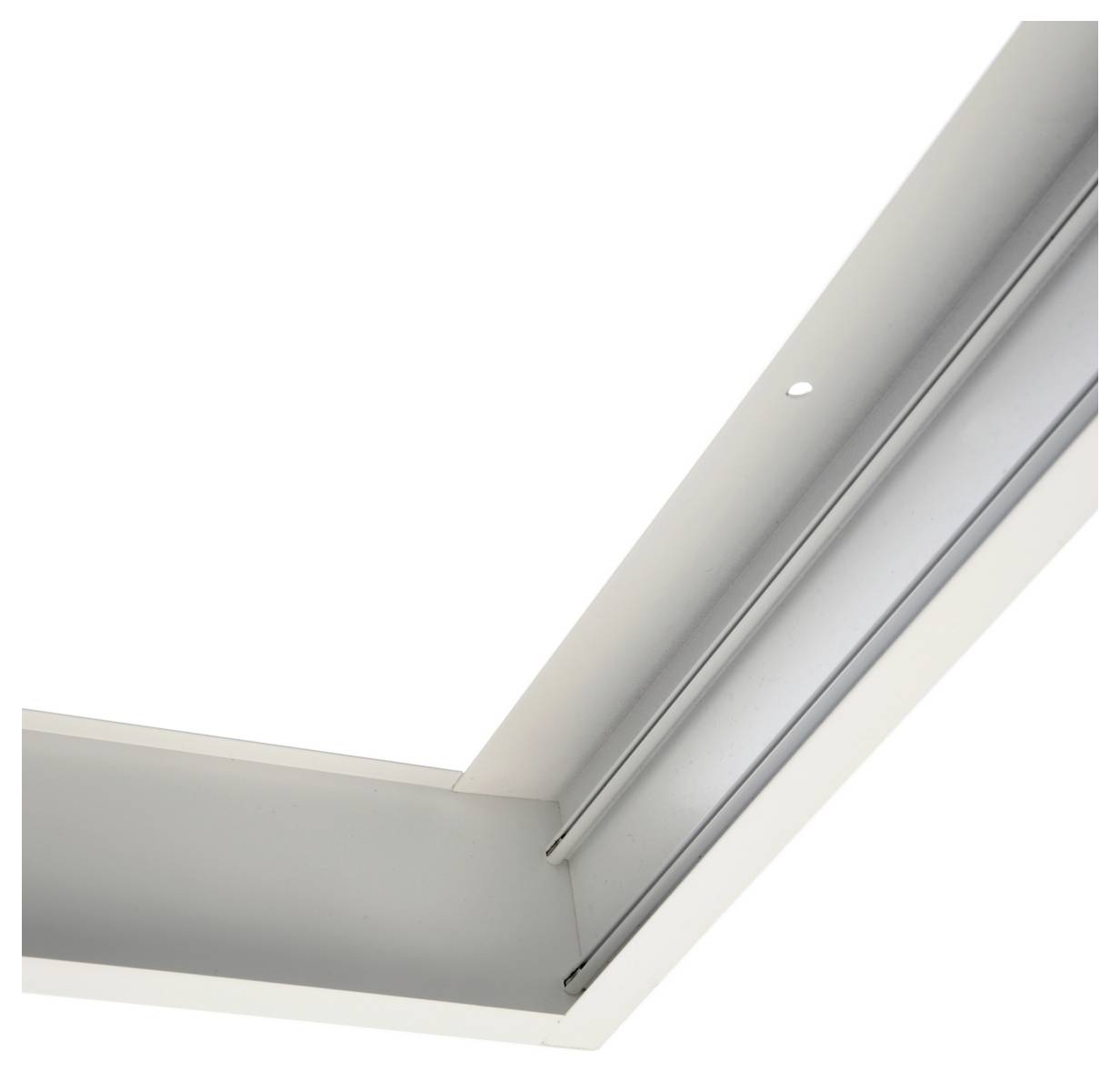 Gros plan d'un cadre d'angle ou d'une moulure de plafond en métal blanc, présentant un détail de canal encastré sur fond uni.