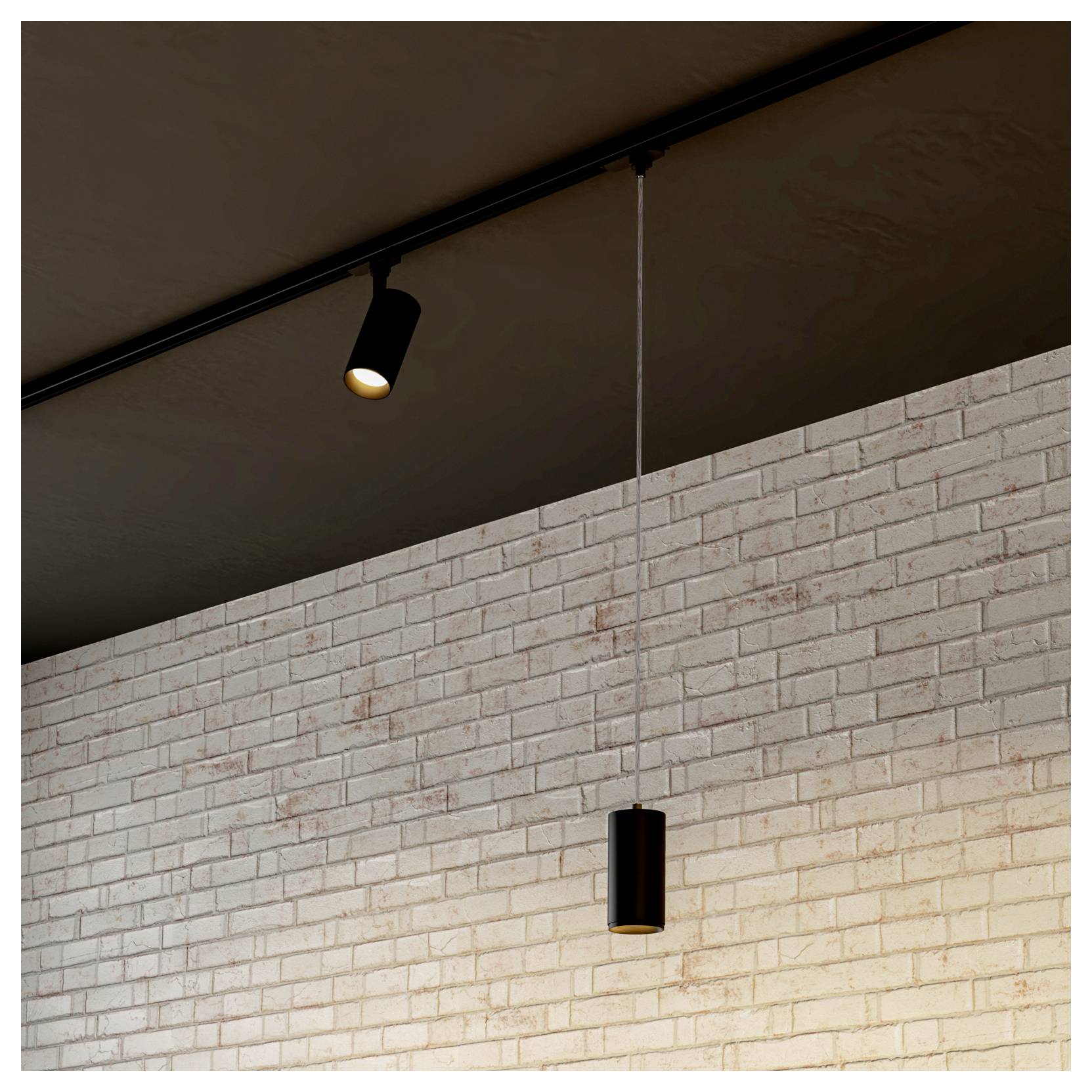 Un éclairage sur rail noir avec un suspension cylindrique illumine un mur en briques blanches dans un intérieur moderne.