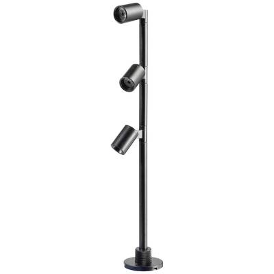 Lampadaire noir avec trois abat-jour cylindriques réglables fixés sur une tige élancée, reposant sur un socle rond.