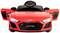 Petite voiture de jouet rouge au design Audi, avec portes ouvertes et volant visible, placée sur un fond uni.