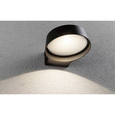 Un luminaire extérieur moderne noir fixé sur un mur gris, orienté vers le bas et projetant une lumière douce sur la surface.