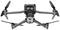Drone grise à quatre hélices et système caméra, modèle 'Mavic 3 Pro', en vol stationnaire, vue de dessous.