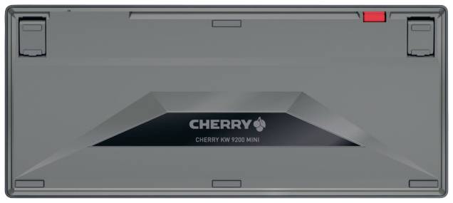 Sous-face d'un clavier portant l'inscription 'CHERRY', numéro de modèle 'KW 9200 MINI'. Un détail rouge est visible en bas à droite.