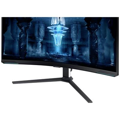 Un moniteur de jeu incurvé avec un écran lumineux affiche un design numérique futuriste en tons de bleu et de noir.