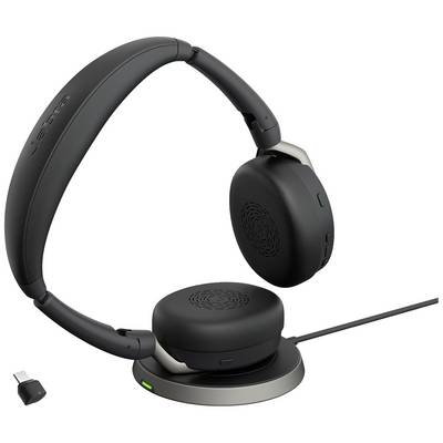 Casque noir sans fil sur une station de charge, avec un petit récepteur USB à côté.