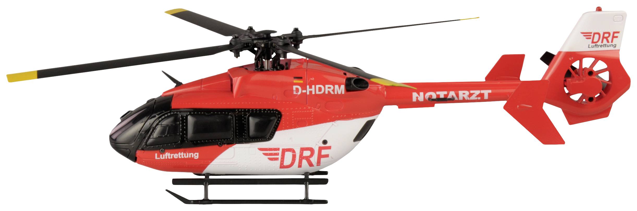 Un modèle réduit d'hélicoptère de la DRF Luftrettung en rouge et blanc, portant l'inscription 'MÉDECIN URGENTISTE' sur le côté.