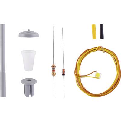 Différents composants électroniques : une résistance, un noyau de ferrite, un fil, un condensateur en plastique, un fil avec une fiche connectée.