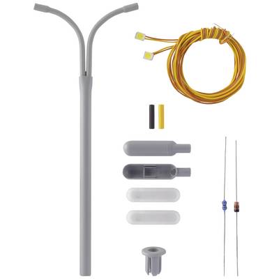 Un kit électrique DIY avec un tube en plastique gris, des fils jaunes, des résistances et des éléments de connexion. Adapté pour les projets électriques.