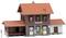 Un petit bâtiment miniature avec un toit rouge et une façade détaillée. Une pancarte portant l'inscription 'Altensteig' est visible.