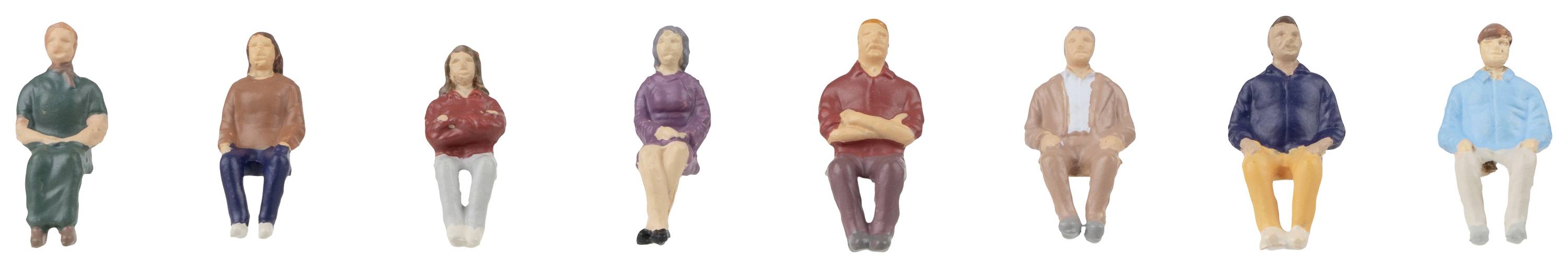 Huit personnages miniatures colorés dans différentes poses et tenues, représentant des personnes exerçant diverses professions ou activités.