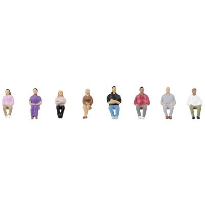 Huit figurines miniatures colorées, positionnées dans différentes postures assises. Elles portent des vêtements et des couleurs variés.