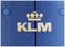 L'image montre le logo KLM avec un lettrage blanc sur un fond bleu. En haut se trouve une couronne stylisée.