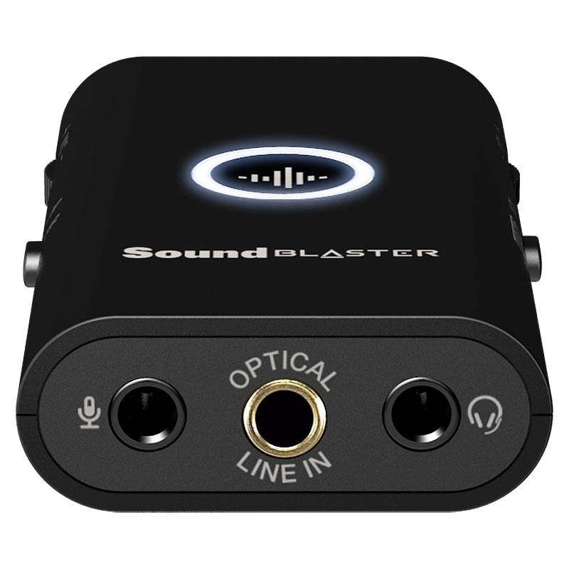 Carte son USB externe en noir avec des connexions pour casque, microphone et entrée optique, logo 'Sound Blaster' visible.
