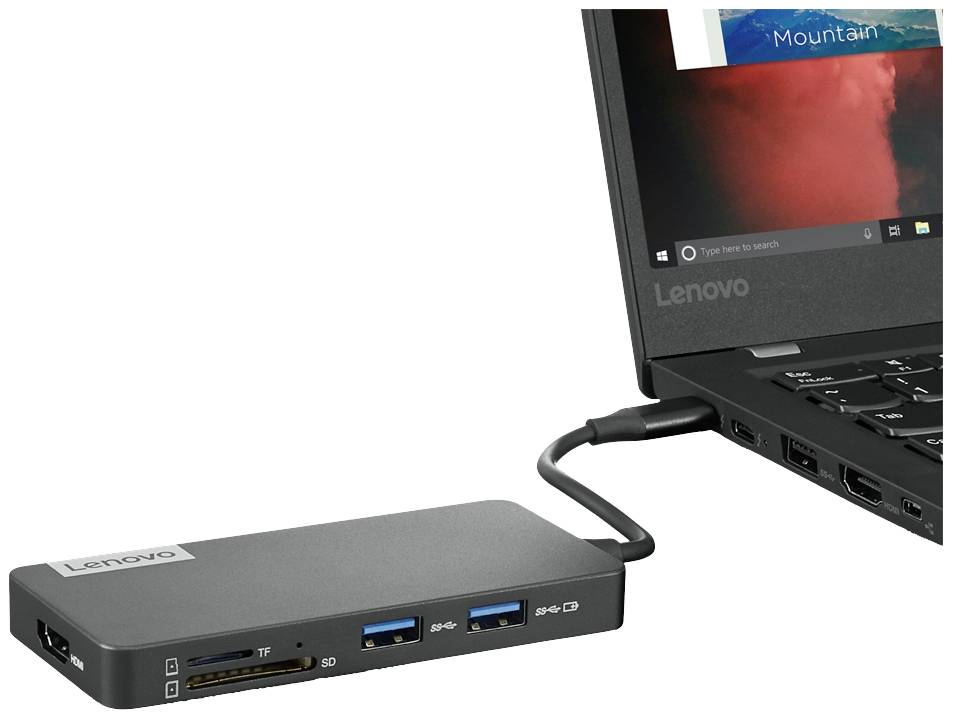 Un ordinateur portable est connecté à une station d'accueil via un câble USB-C. La station d'accueil dispose de différents ports, notamment des ports USB et des emplacements pour cartes SD.