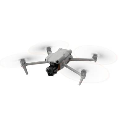 Un drone blanc à quatre hélices vole. Il dispose d'une caméra à l'avant et est en mouvement.