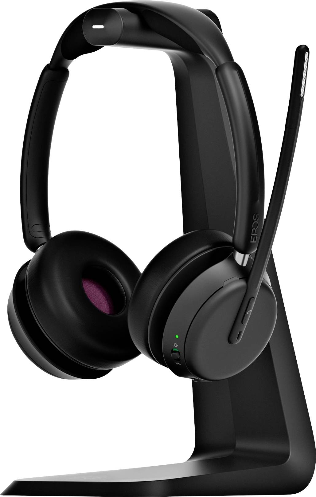 Casque sans fil noir sur un support. Une lumière verte brille sur l'écouteur. Le casque est équipé d'un microphone.