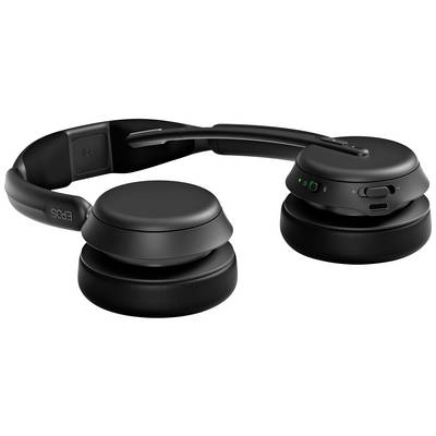 Écouteurs sans fil noirs avec arceau ajustable et coussinets d'oreille doux, posés sur une table, avec port de charge et boutons de commande.