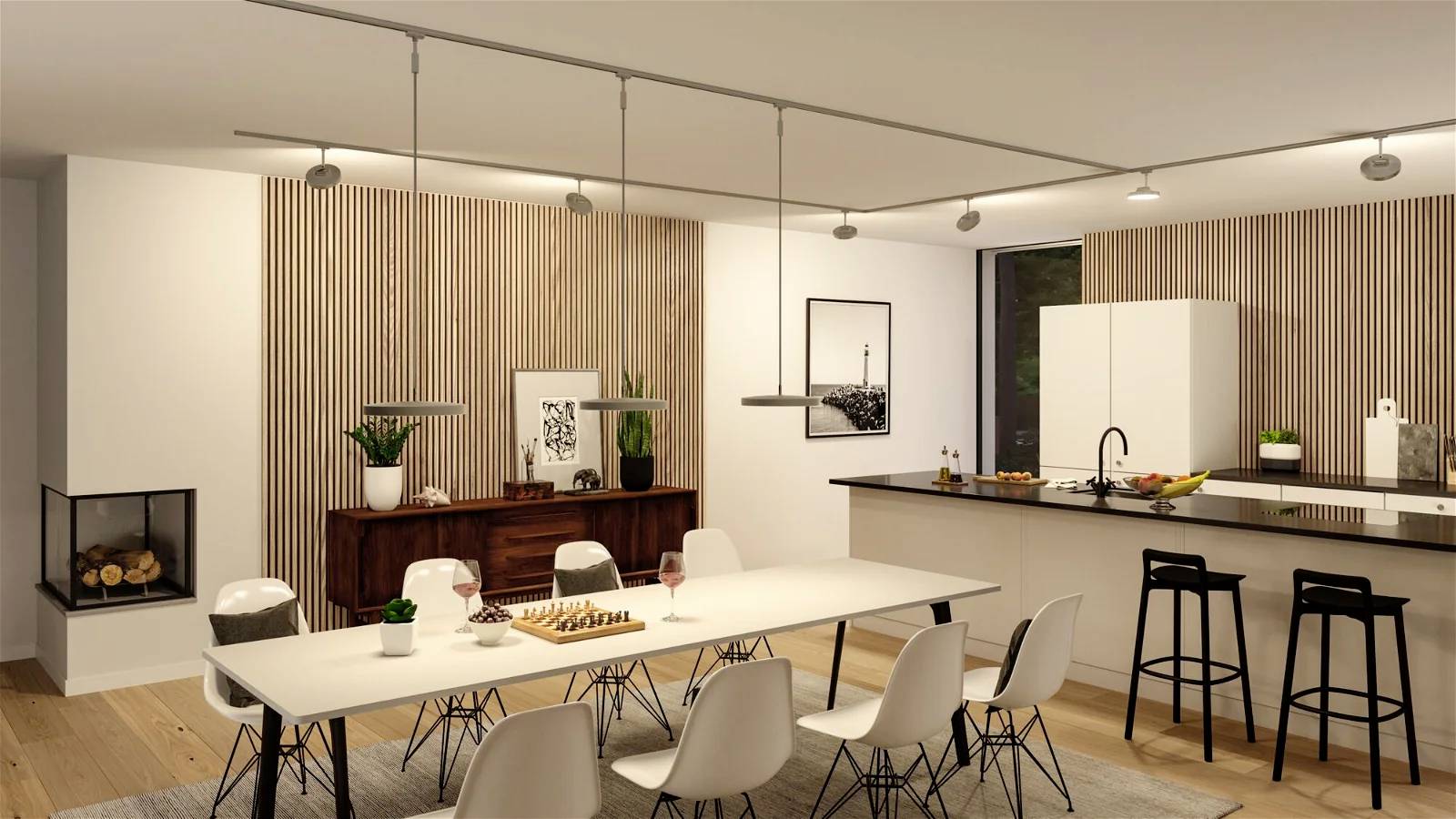 Espace repas moderne avec une longue table, des chaises blanches et un îlot de cuisine en arrière-plan. Couleurs neutres et aménagement élégant.