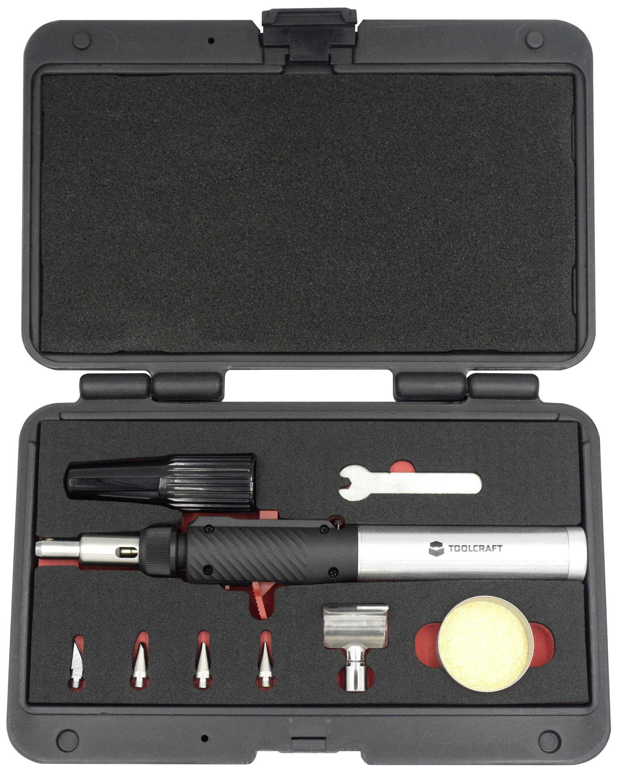 Coffret de fers à souder noir ouvert. Comprend un brûleur, différentes pointes, un outil et une éponge.