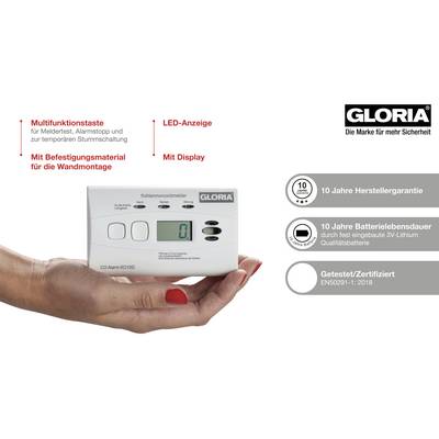 Une main tient un détecteur de monoxyde de carbone de GLORIA. Il affiche '0' sur l'écran. Des marquages décrivent les fonctions : voyant LED, touche multifonction, garantie de 10 ans.