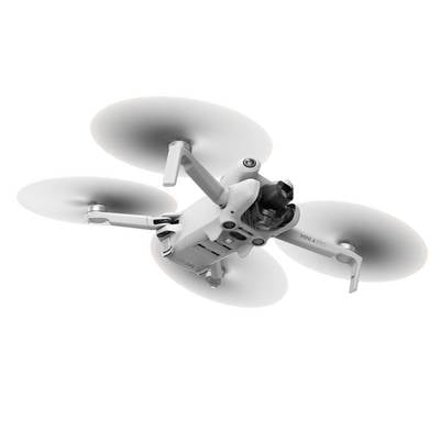 Un drone blanc et gris à trois rotors vole dans les airs. Il est compact et présente des détails technologiques.