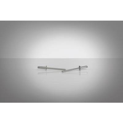 Deux rivets en argent reposent sur une surface lisse et grise, disposés horizontalement.