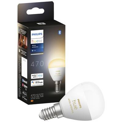 Une ampoule Philips Hue White Ambiance E14 est posée à côté de son emballage. Compatible avec Alexa et Google Assistant.