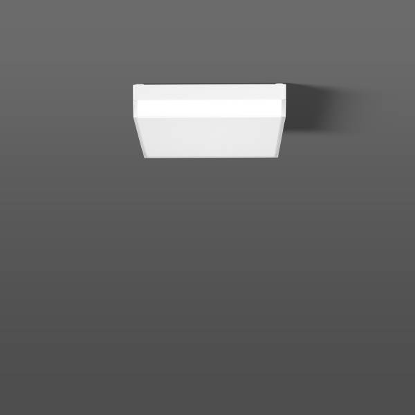 Un simple éclairage blanc carré, monté sur le mur, sur un fond gris.