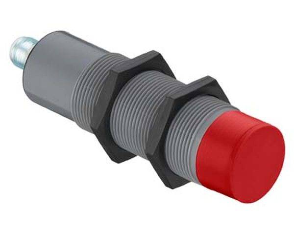 Capteur inductif cylindrique à tête rouge et structure filetée, utilisé pour la détection sans contact d'objets métalliques.