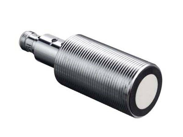Capteur de proximité cylindrique métallique avec boîtier strié et face avant lisse, adapté aux applications industrielles.