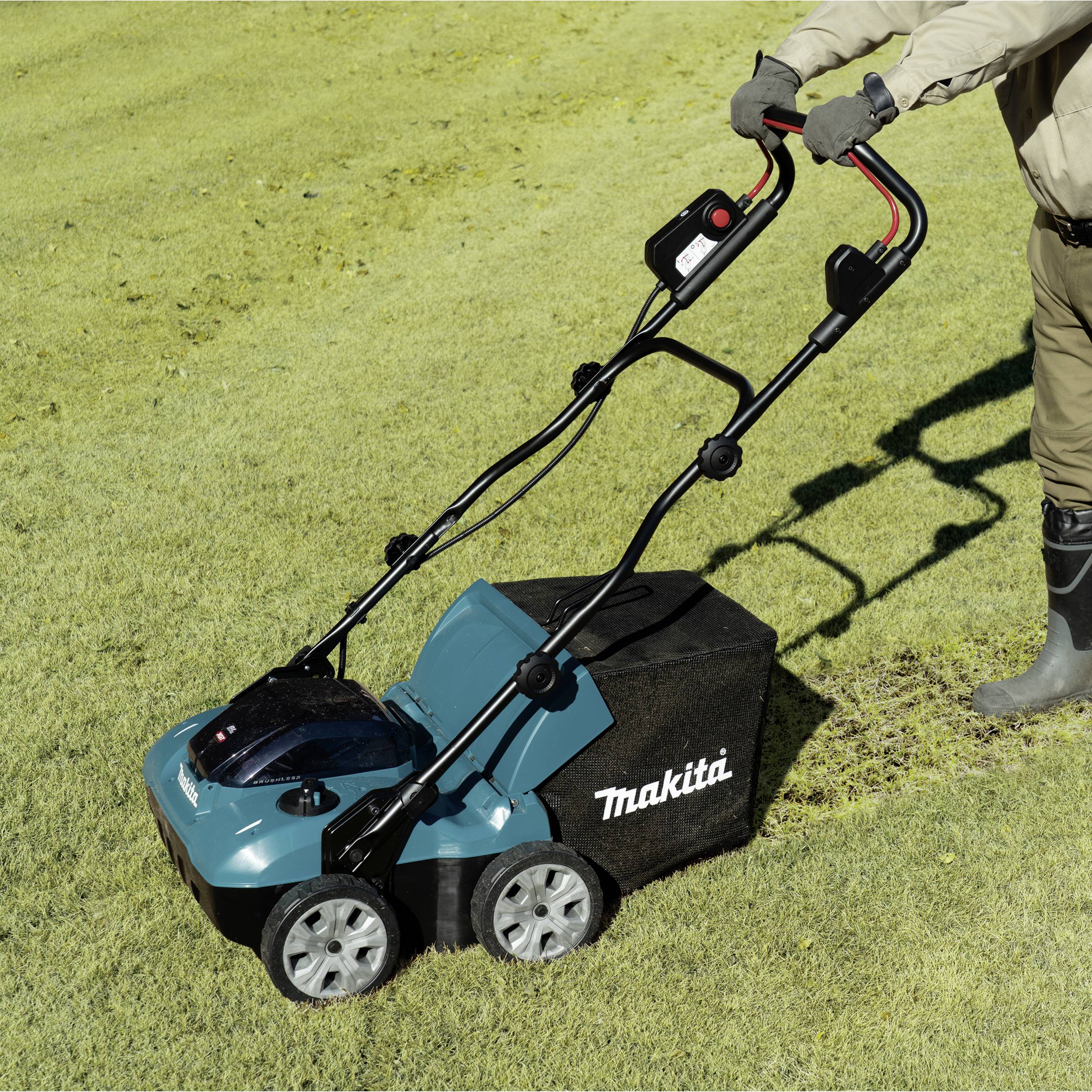 Une personne tond la pelouse avec une tondeuse bleue Makita par une journée ensoleillée. Le logo 'Makita' est visible sur le côté de la tondeuse.