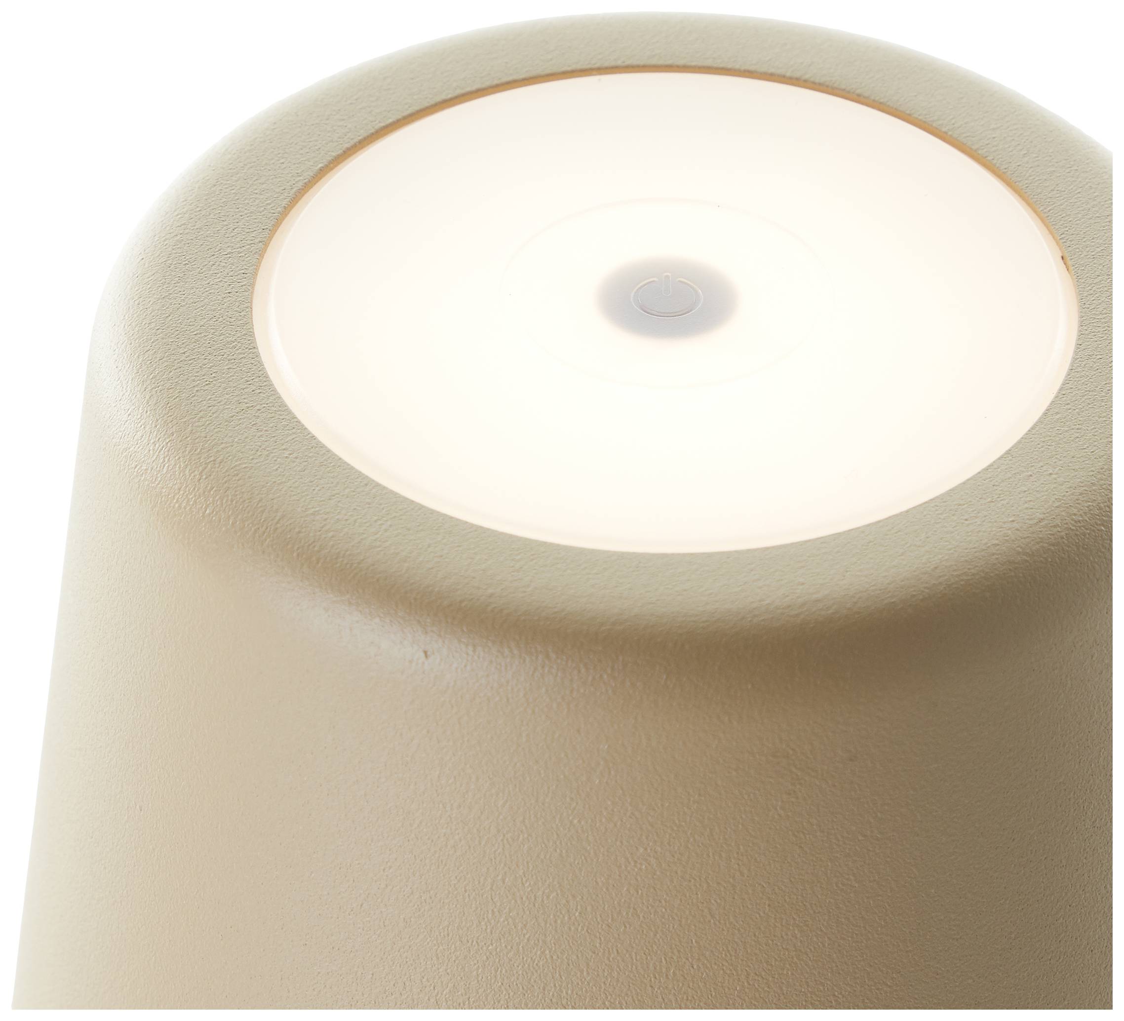 Une lampe beige, photographiée de dessus, avec un cercle lumineux uniformément éclairé au centre.