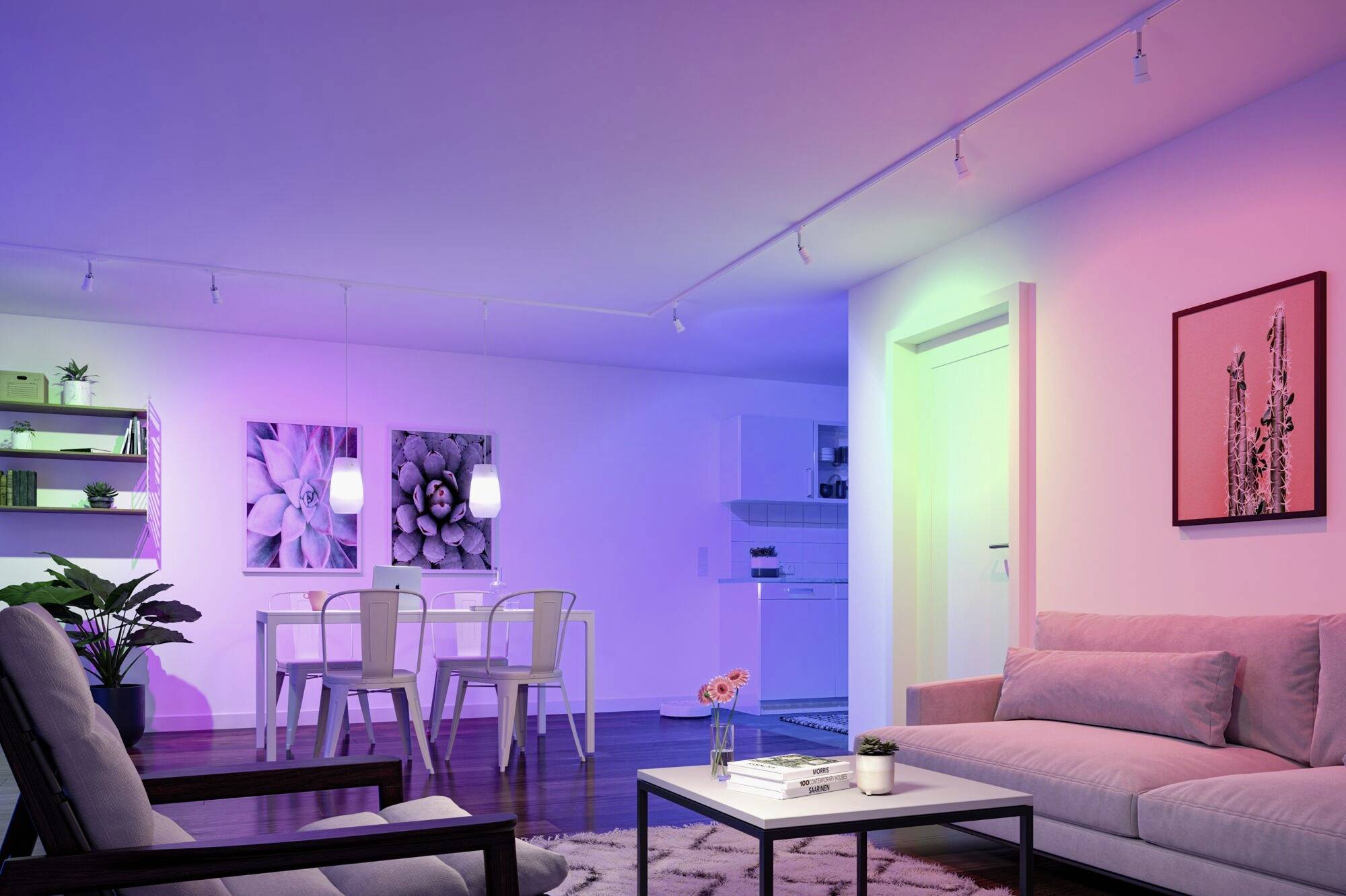 Un salon moderne avec un canapé, une table et des chaises, éclairé par des couleurs LED vives ; des œuvres d'art et des étagères sur les murs.