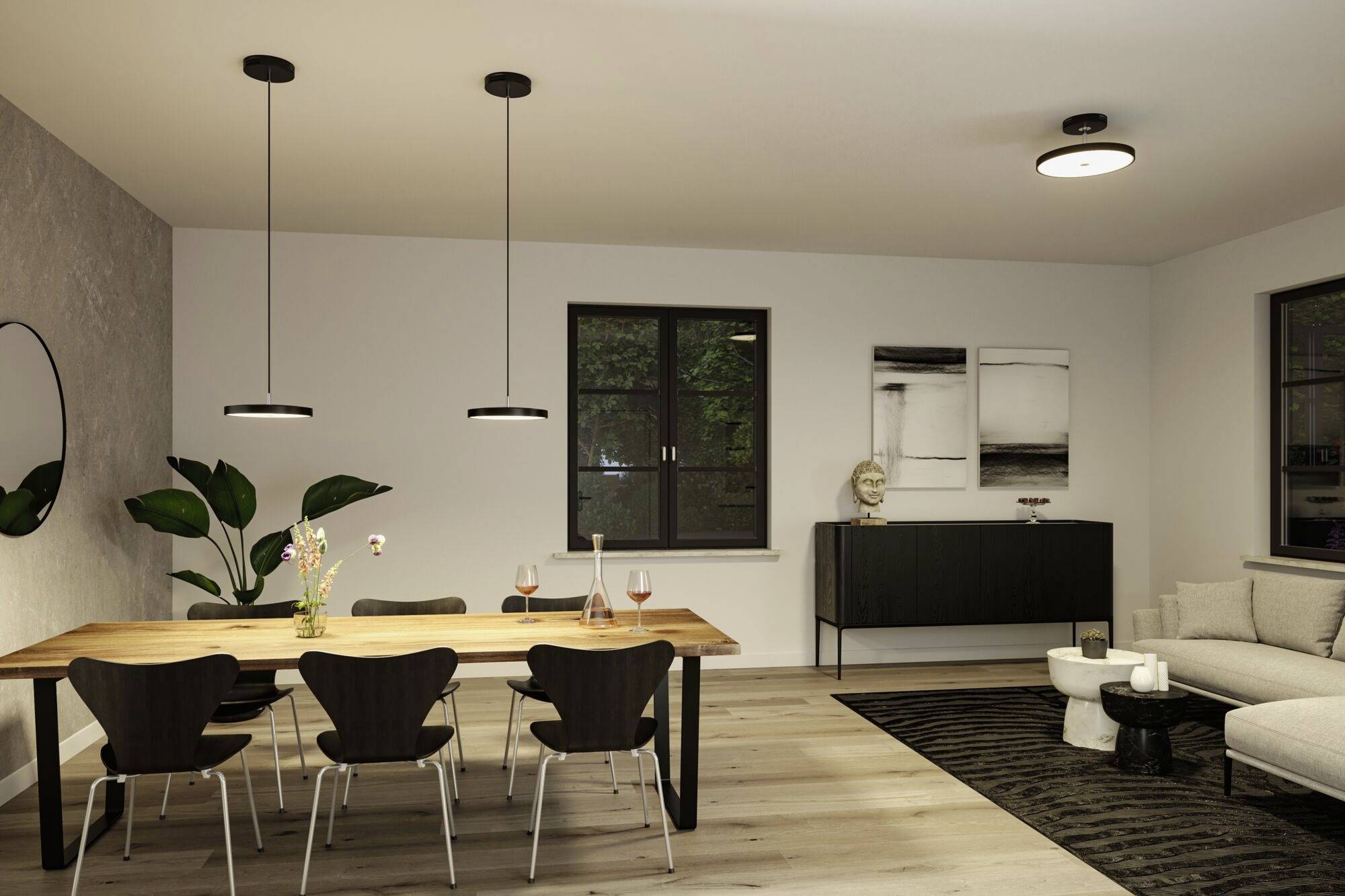 Une salle à manger au design moderne avec une table en bois, des chaises foncées, des œuvres d'art accrochées aux murs, et un éclairage sobre.