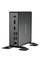 Mini-PC noir de Shuttle avec plusieurs ports à l'avant, dont des ports USB et HDMI, posé sur une table.