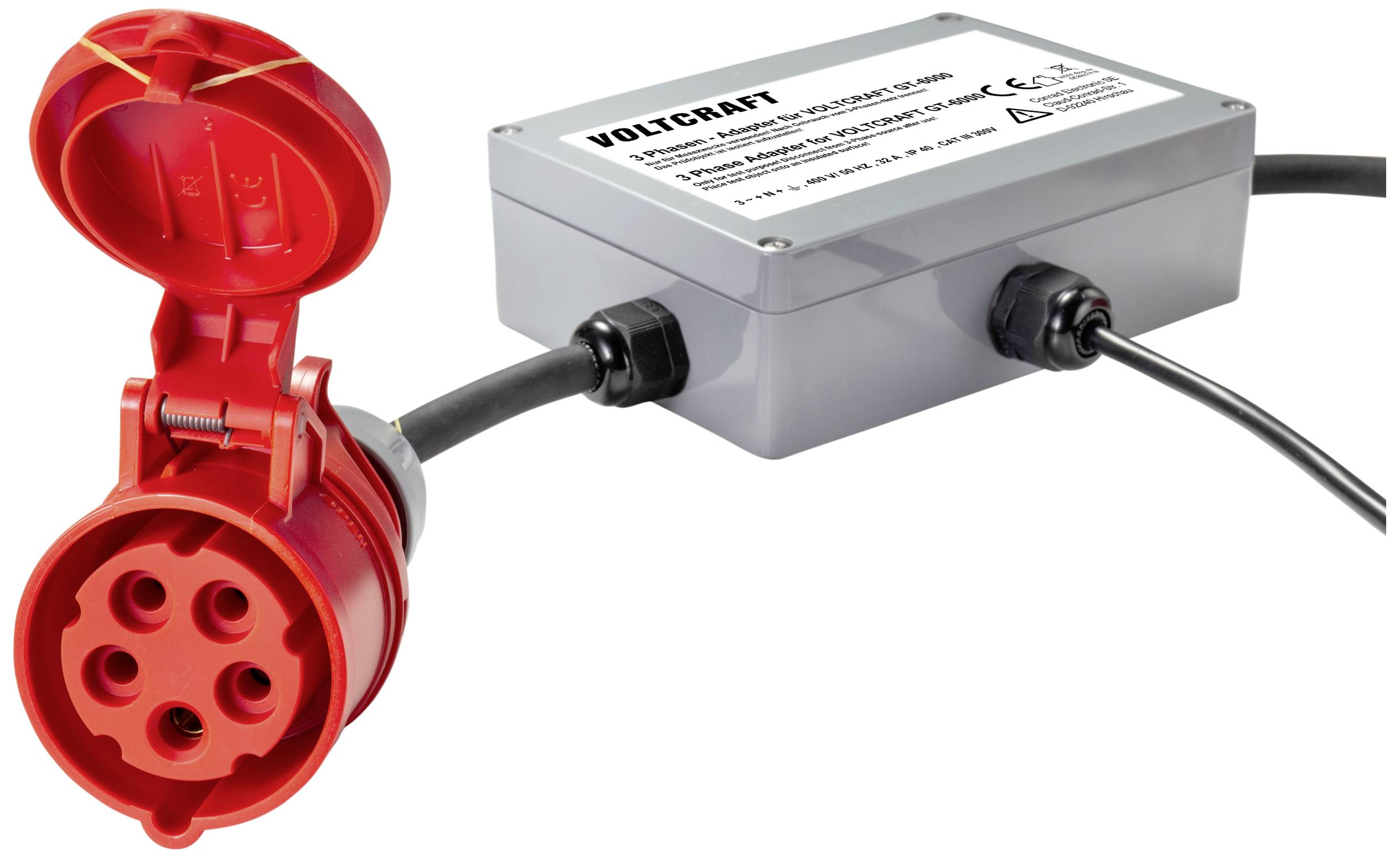 Adaptateur électrique rouge avec boîtier gris et câble noir. Le boîtier affiche 'VOLTCARAT' et des spécifications techniques.