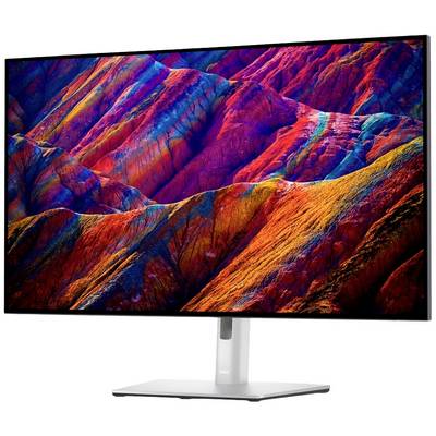 Un écran d'ordinateur affiche un panorama montagneux aux couleurs vives. Les teintes s'étendent du rouge au violet en passant par le bleu, créant une image dynamique.