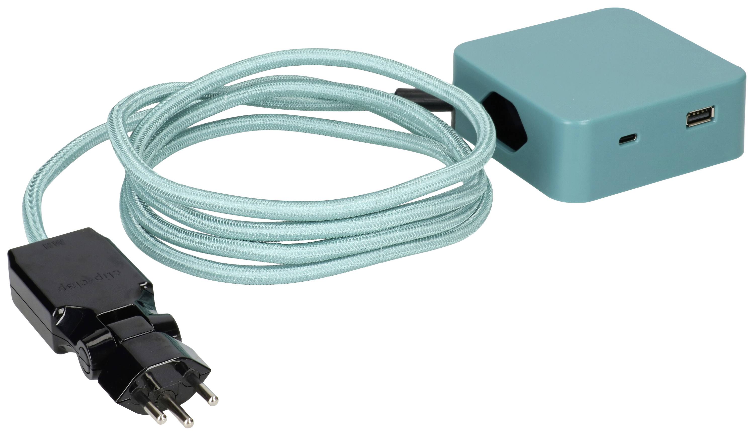 Un appareil électronique turquoise avec port USB, connecté à un câble d'alimentation européen.