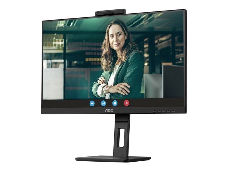 Une personne lors d'un appel vidéo sur un écran d'ordinateur. La personne porte un blazer et sourit légèrement dans un bureau.