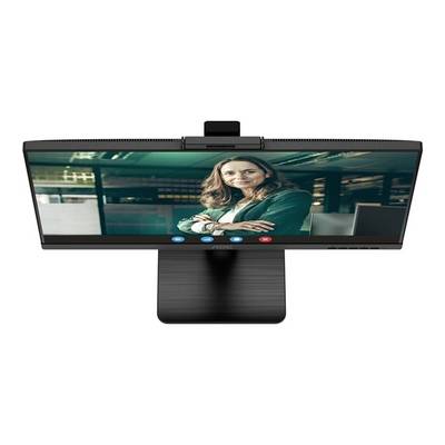 Une femme dans un bureau, visible sur un écran lors d'un appel vidéo. Elle porte un blazer vert.