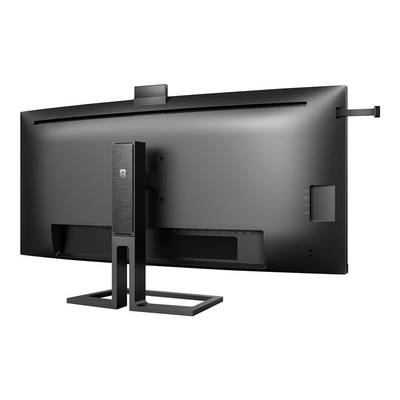 Un grand écran d'ordinateur noir vu de dos. Une petite caméra est installée en haut. Le socle est conçu de manière minimaliste.