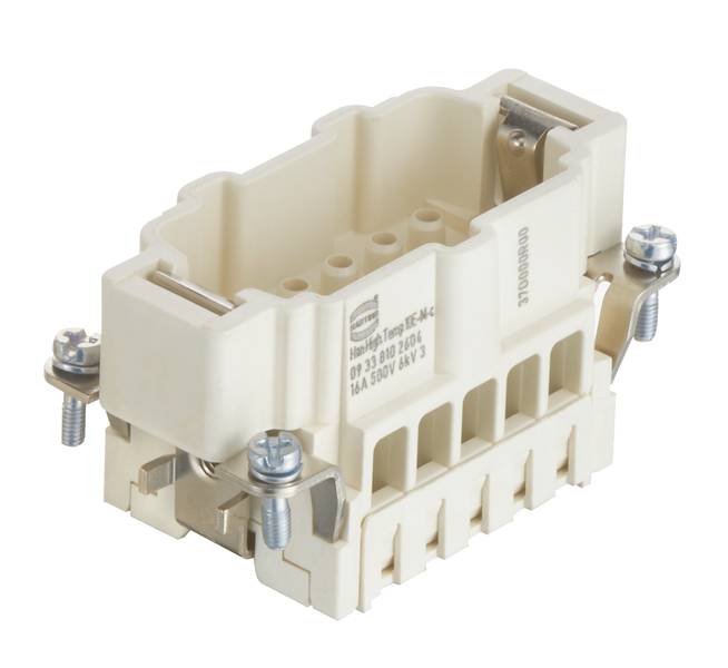 Connecteur rectangulaire en plastique beige avec des éléments métalliques. Quatre vis visibles aux coins pour la fixation.