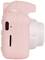 Un appareil photo instantané rose vu de côté, avec port micro-USB et emplacement pour carte mémoire visibles.