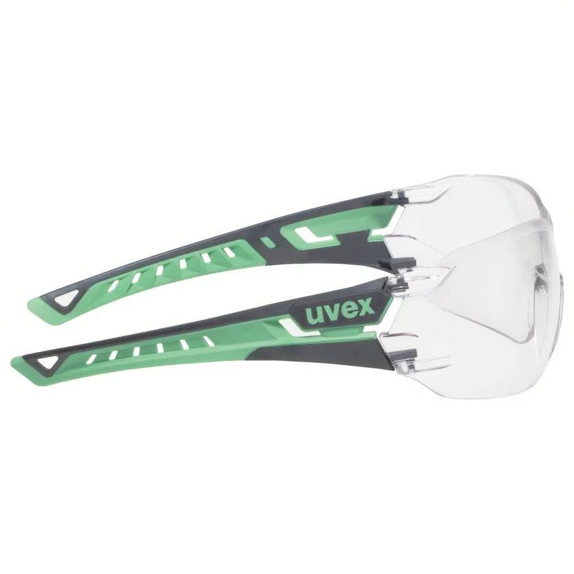 Lunettes de protection avec monture vert et noir et verres transparents. Adaptées pour une utilisation dans des environnements artisanaux ou industriels.