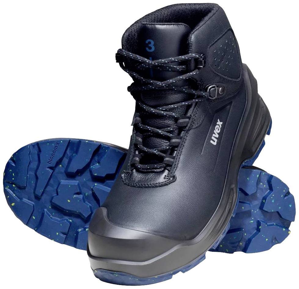 Bottes de sécurité noires avec semelle bleue, centrées à l'avant ; la botte en arrière-plan montre une semelle profilée avec des éclaboussures jaunes.