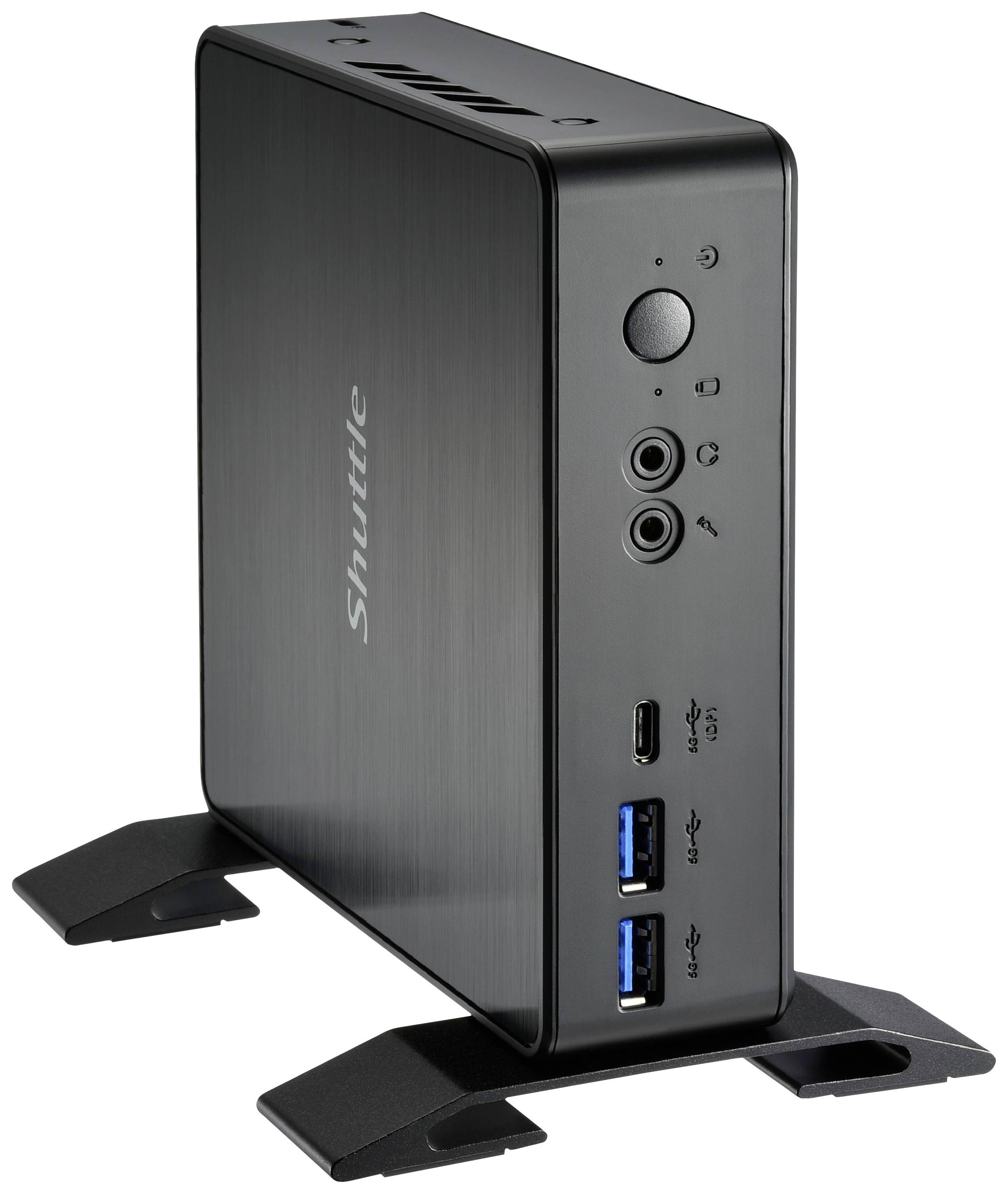 Mini-PC noir compact avec l'inscription 'Shuttle' sur le côté. La façade dispose de ports USB, de connexions audio et de voyants de fonctionnement.