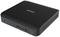 Un petit mini-PC noir de Zotac avec différents ports à l'avant, dont USB et une prise casque.