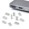 Un port informatique avec des ports VGA et HDMI, à côté desquels se trouvent plusieurs capuchons ou adaptateurs gris qui semblent compatibles.