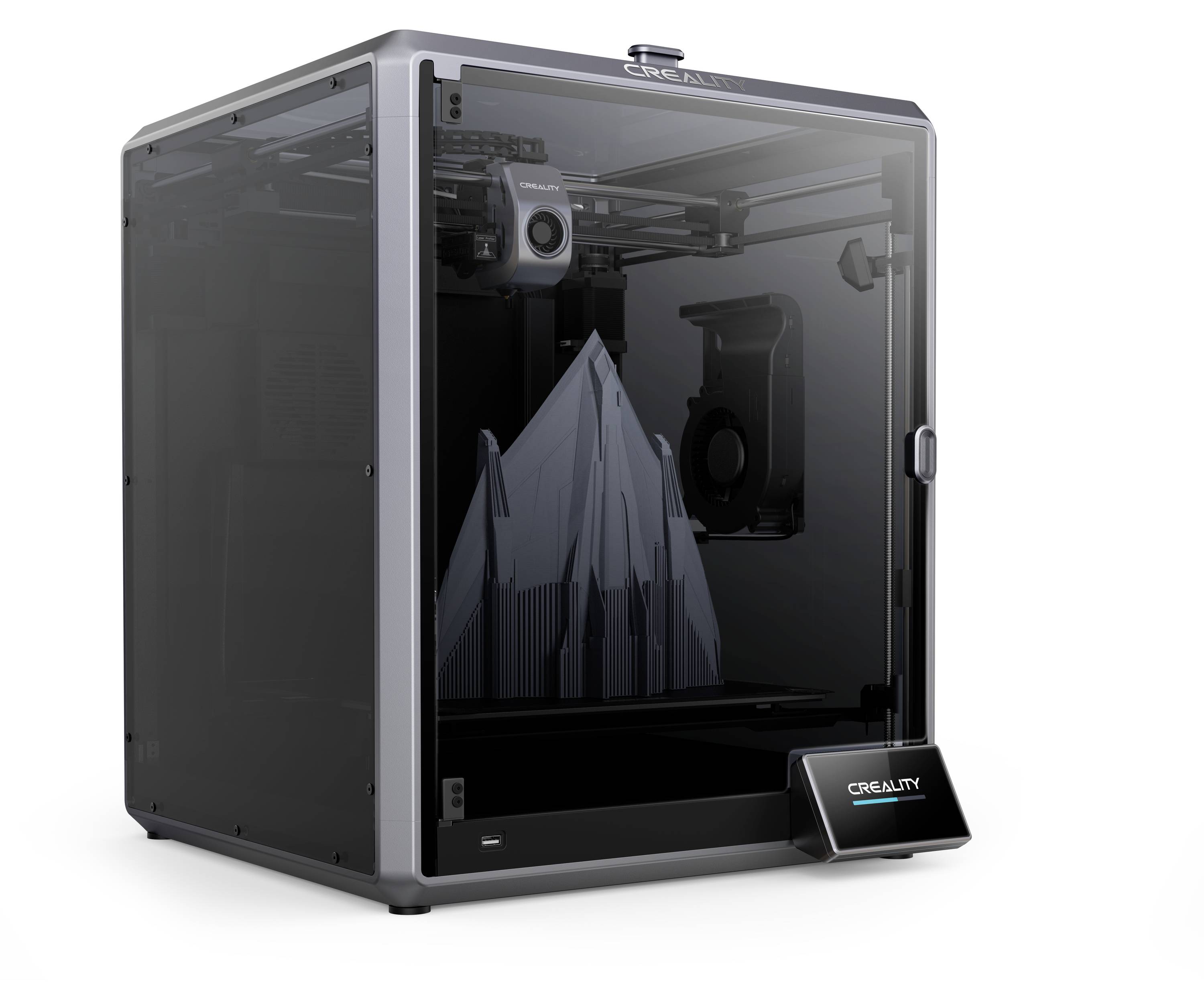 Imprimante 3D avec plateau de construction actif. Un modèle de montagne est en cours d'impression. L'imprimante a un panneau avant transparent et un écran.