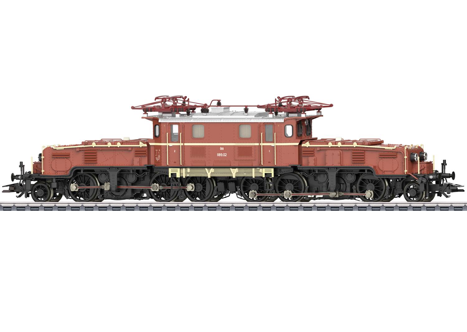 Une locomotive modèle sur un rail, de couleur rouge-brun avec des tampons et des pantographes détaillés, vue de côté.